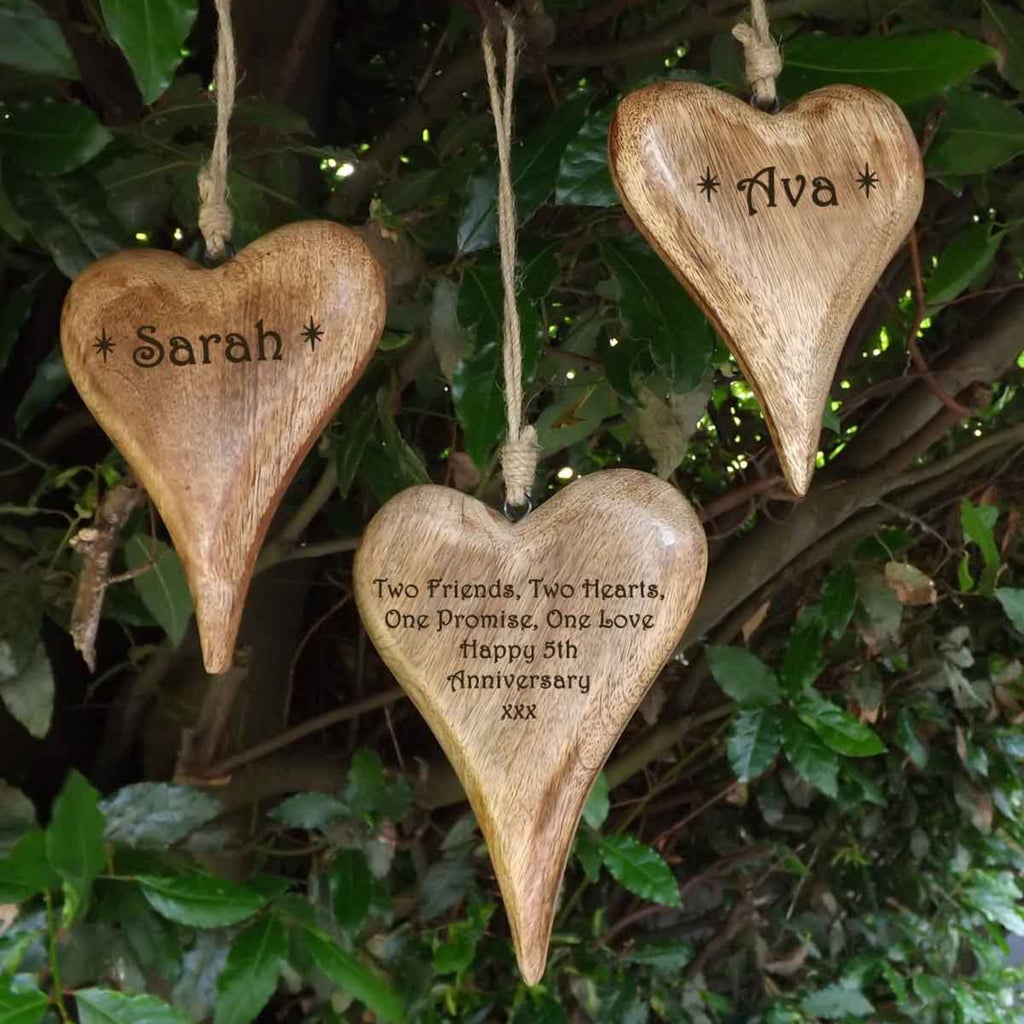 Personalised set of wooden hanging hearts in solid wood - A unique 5th Anniversary Gift